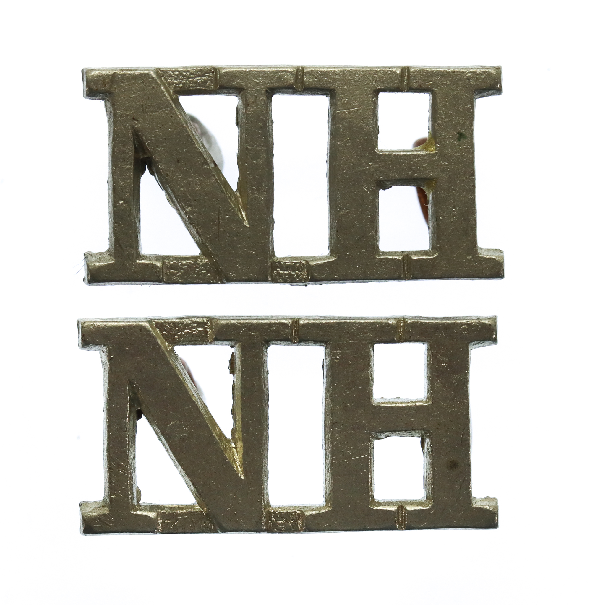 Pair of Northumberland Hussars (N.H.) Shoulder Titles