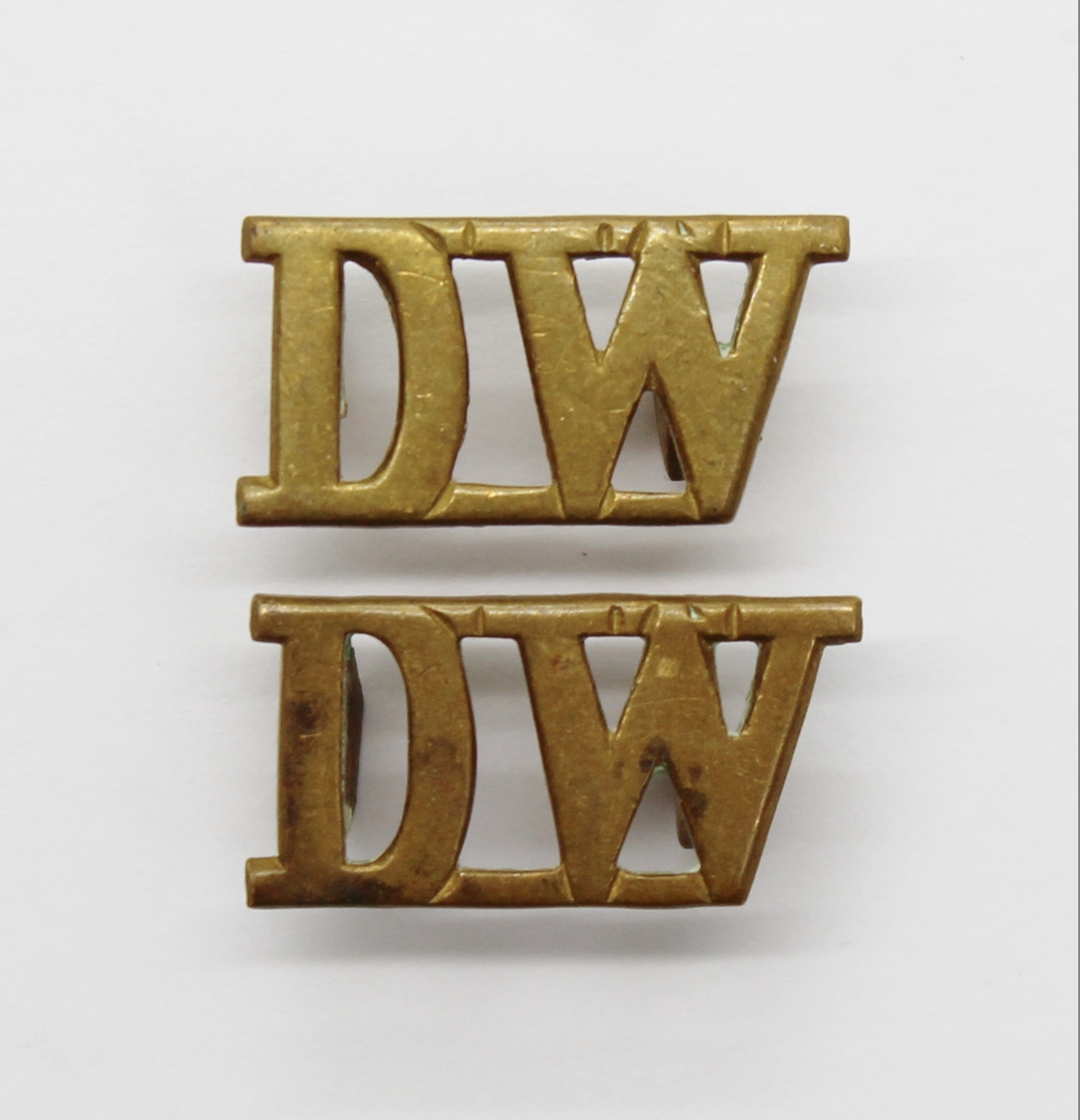 Pair of Duke of Wellington's Regiment (D.W.) Brass Shoulder Titles