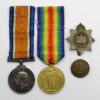 WW1 British War & Victory Medal Pair with Cap Badge & Button - Pte. T. Dewhurst, Devonshire Regiment