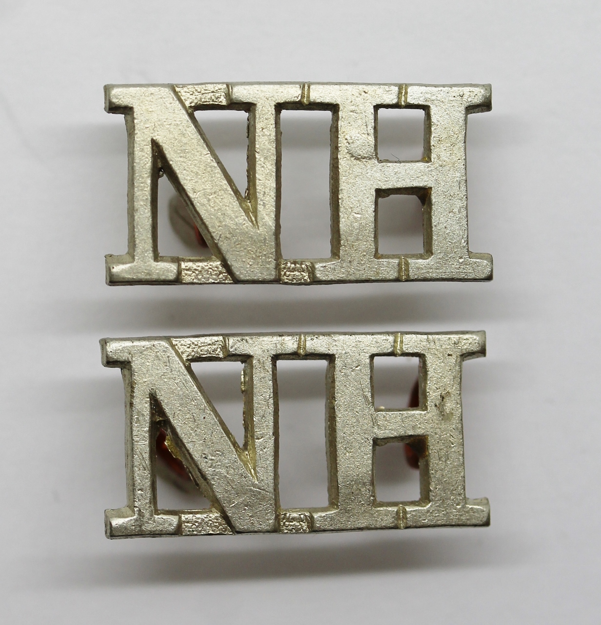 Pair of Northumberland Hussars (N.H.) Shoulder Titles