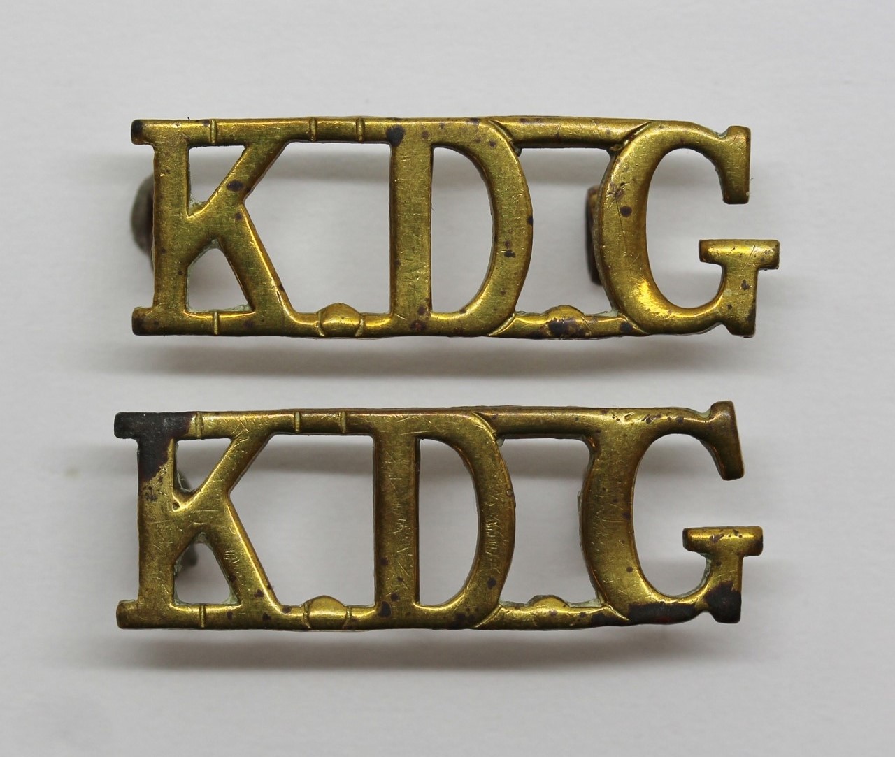 Pair of King's Dragoon Guards (K.D.G.) Shoulder Titles