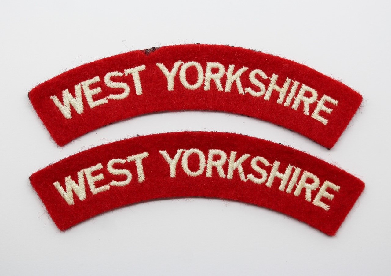 Pair of West Yorkshire Regiment Cloth Shoulder Titles