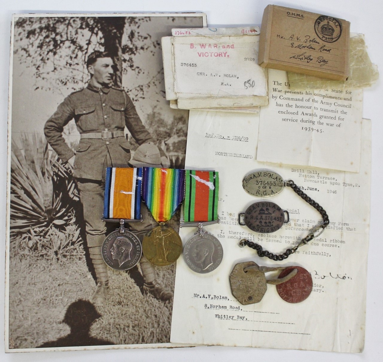 WW1 British War Medal, Victory Medal and WW2 Defence Medal with Dog Tags, Identity Bracelet and Boxes of Issue - Gnr. A.V. Bolam, Royal Artillery